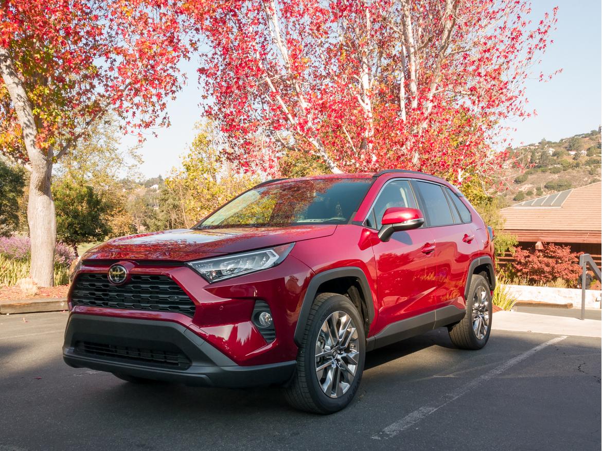 12-<a href=https://www.sharperedgeengines.com/used-toyota-engines>toyota</a>-rav4-limited-2019-angle--exterior--front--red--trees.j