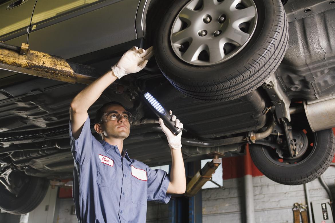 Car technician detecting transmission issues